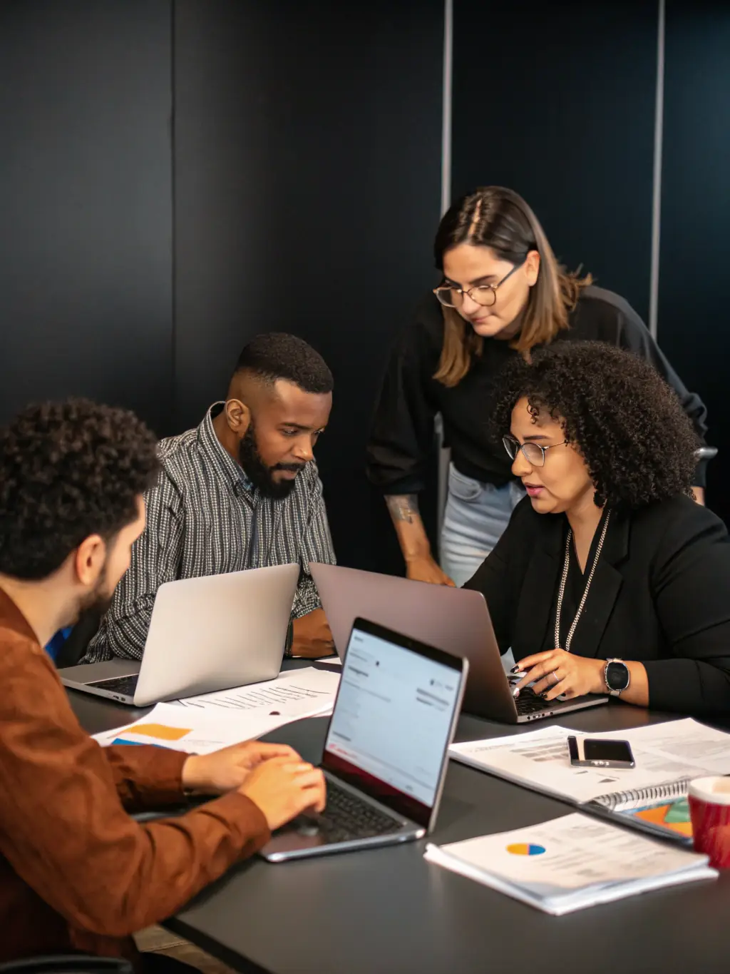 A photo of a modern office with people from different ethnic backgrounds working together, representing global collaboration.